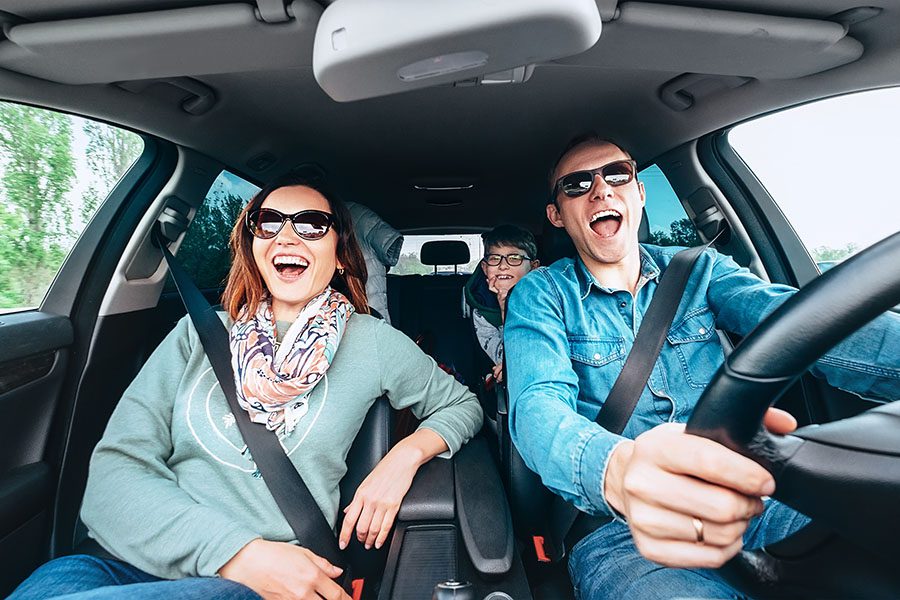 About Our Agency - Excited Family Singing In The Car While On A Road Trip